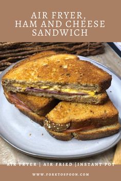 a grilled ham and cheese sandwich on a plate with the words air fryer ham and cheese sandwich