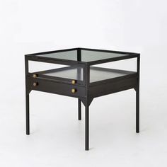 a small black table with two drawers on one side and an open drawer on the other