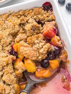 a casserole dish filled with fruit and crumbs