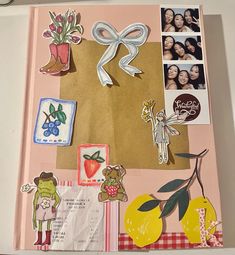 an open scrapbook with pictures and stickers on it's cover is shown