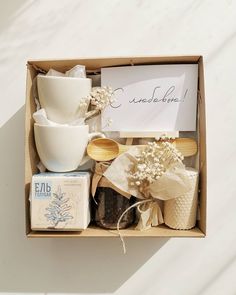 an open box containing various items such as cookies, soaps and coffee mugs