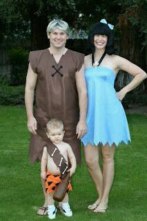 a man, woman and child dressed up in costumes