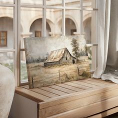 an easel sitting on a window sill with a painting in front of it