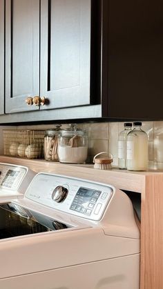 a washer and dryer sitting in a kitchen next to each other on top of a counter