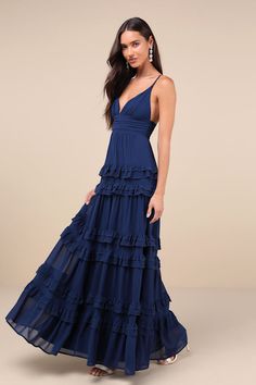 Simple yet stunning, there are so many elements of the Lulus Lavish Perfection Navy Blue Ruffled Tiered Maxi Dress that you'll love! This lovely dress is composed of lightweight woven chiffon that shapes a lightly gathered bodice, a flirty V-neckline, and adjustable spaghetti straps. The high, pleated banded waist tops an elegant A-line maxi skirt adorned with tiers of ruffled detailing throughout for an ultra-femme finish. Hidden back zipper/clasp. Fit: This garment fits true to size. Length: F Blue Bell Sleeve Dress, Fall Formal Dresses, Blue Wedding Guest Dresses, Blue Boho Dress, Navy Blue Gown, School Dance Dresses, Navy Blue Maxi Dress, Blue Dress Formal, Tiered Ruffle Dress