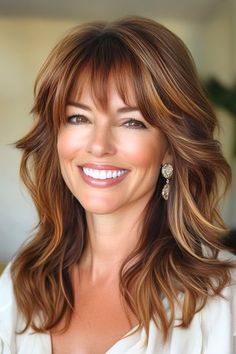 Save this pin for the best layered hair with bangs ideas. Soft waves cascade down into layered tiers in this stunning longer cut. Layered waves with piecey bangs offer a perfect mix of softness and structure, adding natural bounce and dimension to your hair. Over 50 Curtain Bangs, Long Layers In Shoulder Length Hair, Side Part Bangs Medium Hair, Full Bangs Layered Hair, Longer Length Haircut, Long Wavy Layered Hair With Bangs, Shag Hairstyles Long Bangs, Med Long Hairstyle Women, Mid Length Feathered Hair