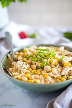 a bowl filled with rice and corn on top of a table