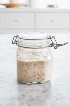 a glass jar filled with food sitting on top of a counter