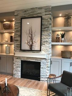 a living room filled with furniture and a fire place in front of a stone fireplace