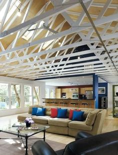 a living room filled with furniture and lots of windows