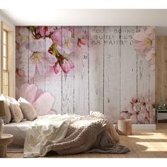 a bedroom with flowers painted on the wall and wooden flooring, along with a bed