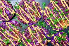 purple cabbage covered in mustard and garnished with parsley on a baking sheet