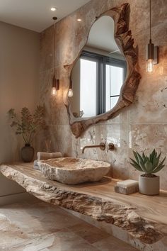 a bathroom with stone walls and a large mirror on the wall above the sink, along with a potted succulent plant