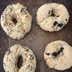 four bagels with sesame seeds and blueberries