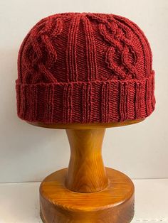 This Cable-knit hat is made from 100% Merino wool. It is 22" adult sized hat and very warm. Hand wash and air dry. Can be made in other colors on request. Warm Red Yarn Hat, Casual Cable Knit Hat, One Size, Red Knit One-size Hat, Warm Red Hat, One Size, Red Hand-knitted Beanie Cap, Cable Knit Hat, Oct 1, Knit Hat, Other Colors