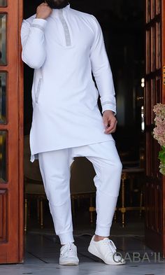 QL EMINENCE Short Kamisweat in White and SilverDescription:Look simple, clean and elegant in this short Kamisweat. It provides a unique style statement with leisure and comfort. Made fashionably stylish by adding a matching rectangular Greek ins... Kurta Simple, Kurta Pattern, Party Bottoms, Gents Kurta, Outfit Essentials, Going For A Walk, White Kurta, Relaxed Trousers