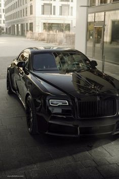 a black car parked on the side of a street