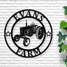 a metal sign that says evans farm with a tractor in the center and stars around it