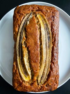 a loaf of banana bread on a white plate