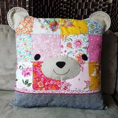 a patchwork pillow with a bear on it