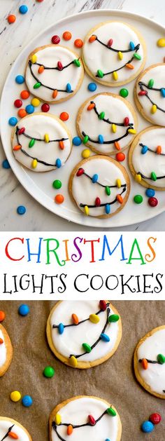 christmas cookies decorated with white icing and colorful candies are on a platter