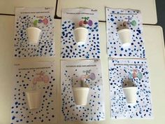 four white cups sitting on top of each other in front of blue and white polka dots