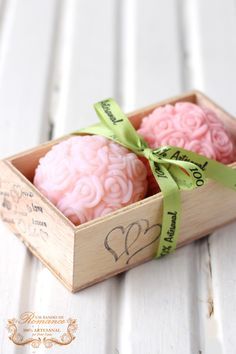 two cupcakes in a wooden box with ribbon