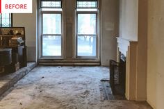 an empty living room with two windows and carpet