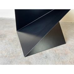 a black metal object sitting on top of a floor