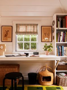 a home office with bookshelves and baskets on the desk