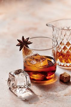 two glasses filled with ice and aniset on top of a white countertop