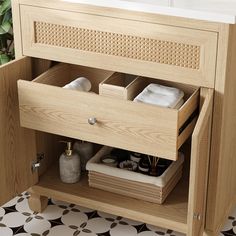 a wooden cabinet with drawers and towels in it