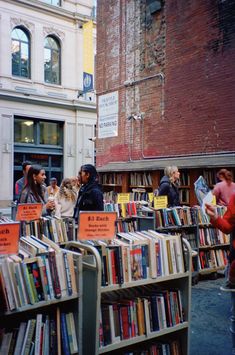 people browse through books at an outdoor book market