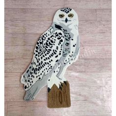 an owl rug is on the floor with a brown base and black dots around it