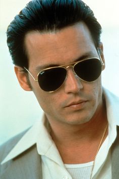 a man wearing sunglasses and a white shirt