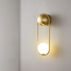 a light that is on the wall next to a white wall with a lamp in it