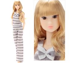 a doll with blonde hair wearing pajamas and a bow tie