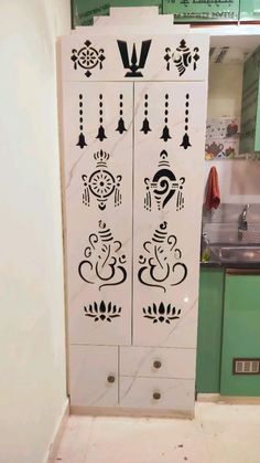 a white cabinet with designs on it in a kitchen