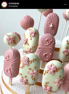 pink and white cake pops with flowers on them