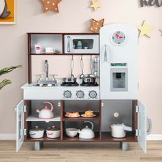 a toy kitchen with various appliances and accessories