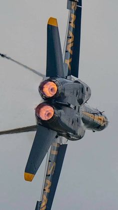 a fighter jet flying through the air with its lights on