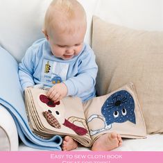 a baby sitting on a couch with a book in it's lap and the text easy to sew cloth book for babies