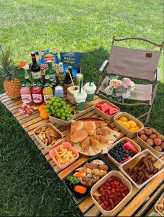 a picnic table filled with lots of food and drinks on it's trays