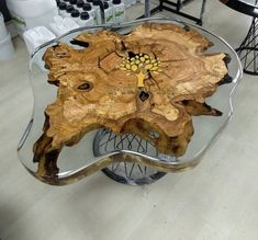 a table made out of wood and glass on top of a hard wood floor in a store