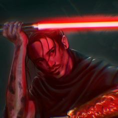 a man holding a red light saber in his right hand and looking at the camera