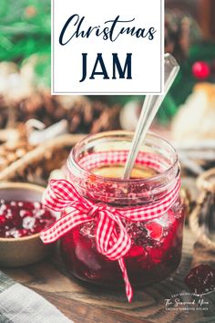 a jar filled with jam sitting on top of a table next to a bowl of cranberry sauce