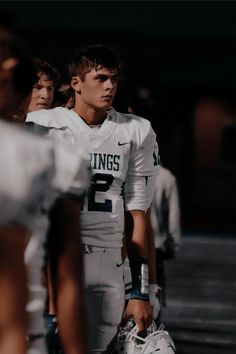 a football player is standing on the sidelines