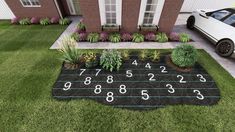 a car is parked in front of a house with numbers on the lawn and plants