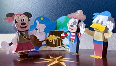 mickey mouse, donald duck and goofy duck are standing next to each other in front of a star