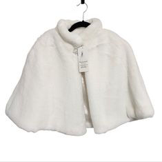 a white fur cape hanging on a clothes hanger